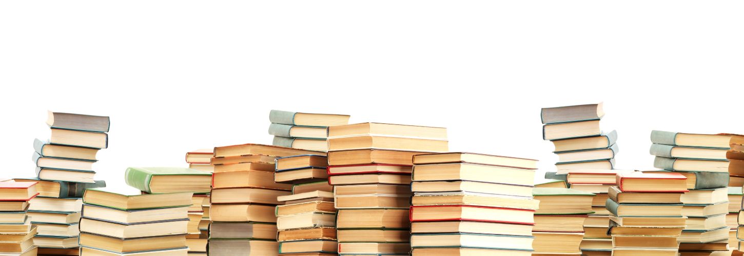 Stacks of various books with colorful spines and pages facing outwards, creating a scattered yet vibrant pattern against a plain white background.